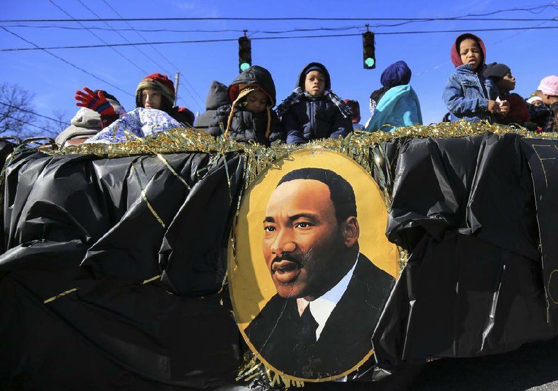 Children from First Liberty Hill Missionary Baptist Church ride a float Monday along MLK Drive in Little Rock during the NAACP Marade honoring civil-rights leader Martin Luther King Jr. For more photos see www.arkansasonline.com/galleries 
