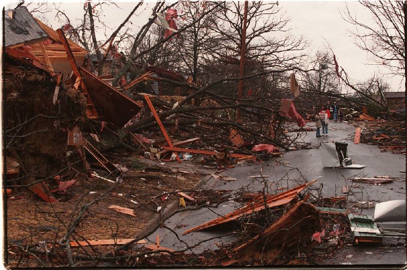 Residents survey the damage Jan. 22, 1999, on Battery Street in Little Rock after a tornado hit the area the previous night. The tornado was part of the largest tornado outbreak in state history, with 56 twisters spawned in Arkansas over a 24-hour period. 