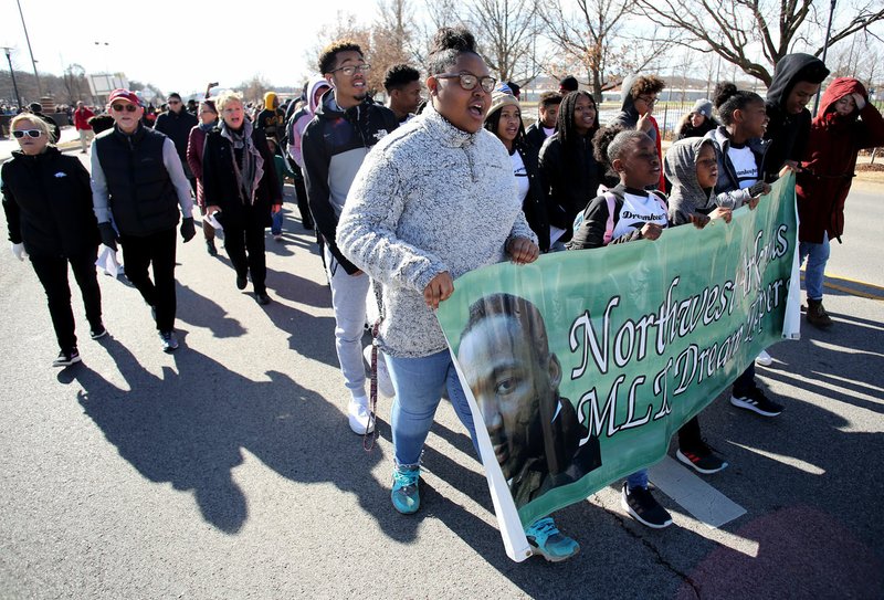 NWA Democrat-Gazette/DAVID GOTTSCHALK Members of the Northwest Arkansas Dream Keepers and friends carry a banner Monday in the annual Martin Luther King Jr. Freedom March to the campus of the University of Arkansas in Fayetteville. Participants in the march, sponsored by the Northwest Arkansas Martin Luther King Jr. Council, began near the corner of Razorback Road and Martin Luther King Jr. Boulevard and marched, sang and chanted to the Arkansas Union for the Martin Luther King Jr. vigil presented by the University of Arkansas Black Student Association with the Associated Student Government. The keynote speaker was Angela Mosley Monts, assistant vice chancellor for diversity and inclusion at the university.