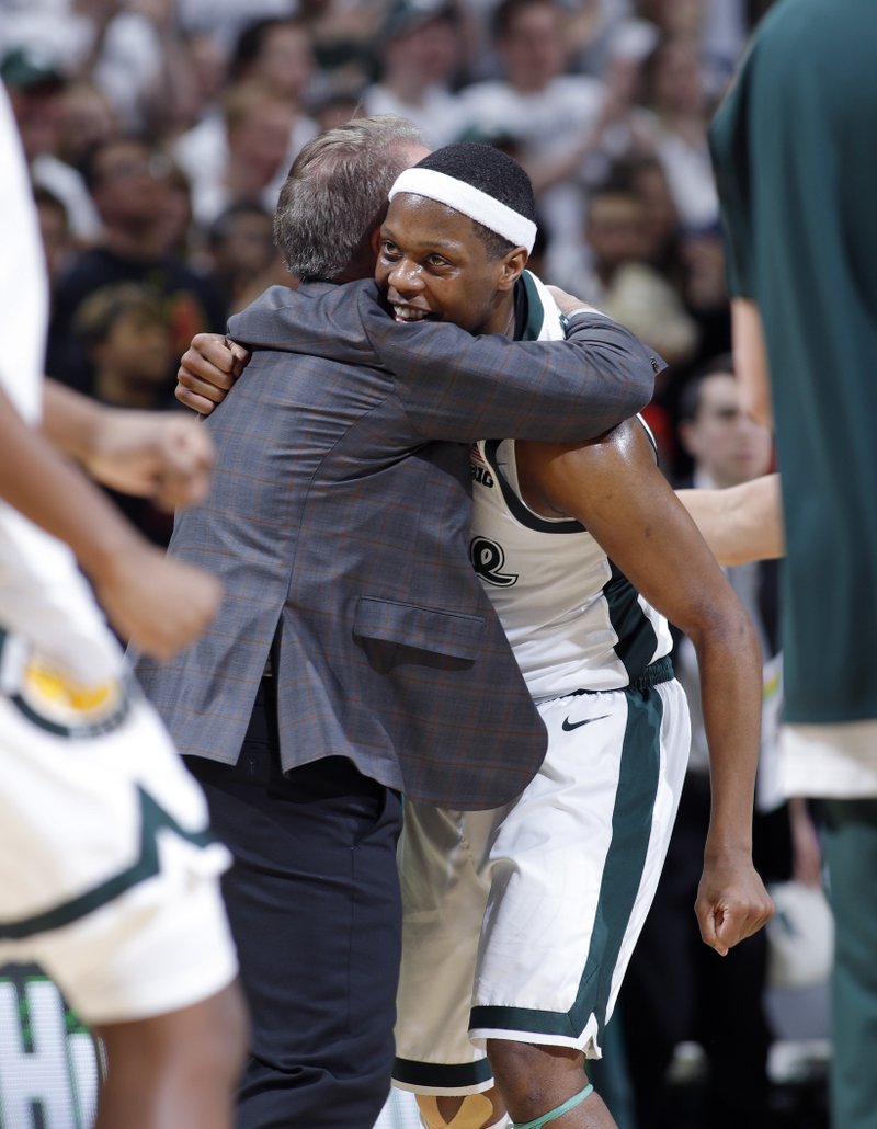Michigan State coach Tom Izzo, left, hugs Cassius Winston during a timeout the second half of an NCAA college basketball game against Maryland, Monday, Jan. 21, 2019, in East Lansing, Mich. Michigan State won 69-55. (AP Photo/Al Goldis)