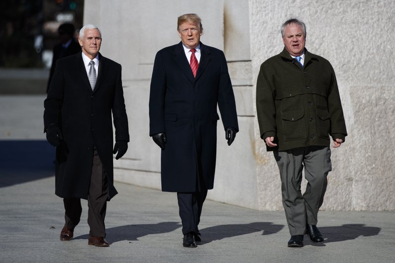 President Donald Trump, center, Vice President Mike Pence, left, escorted by Acting Interior Secretary David Bernhardt, right, visit the Martin Luther King Jr. Memorial, Monday, Jan. 21, 2019, in Washington. (AP Photo/Evan Vucci)