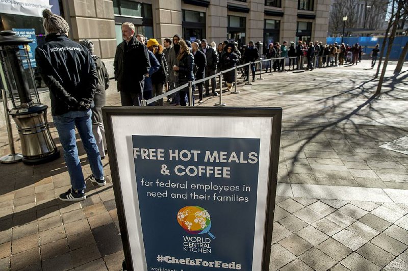 Furloughed federal workers get food and supplies Tuesday from the nonprofit World Central Kitchen, which provides aid after natural disasters, at a distribution center just blocks from the U.S. Capitol. 