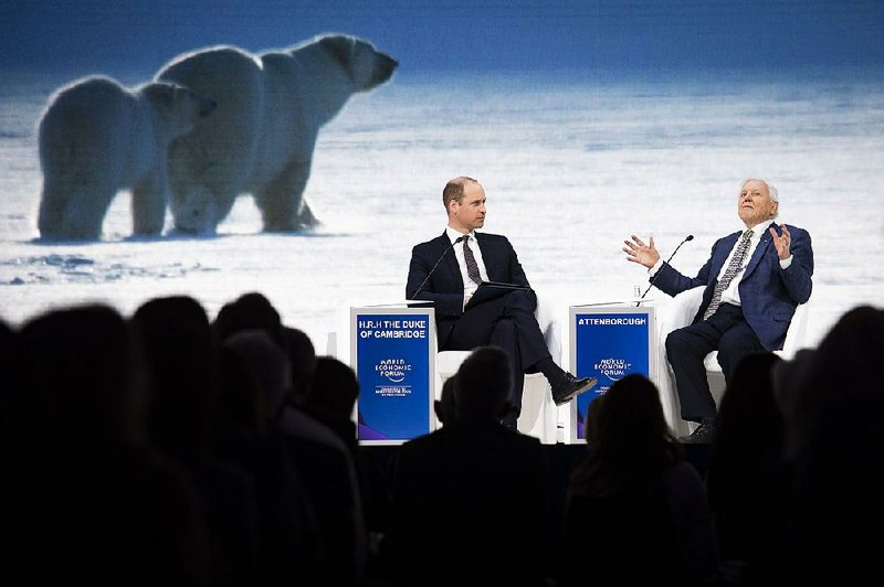 Britain’s Prince William (left) listens to Sir David Attenborough, broadcaster and natural historian, during a session Tuesday at the World Economic Forum in Davos, Switzerland. 