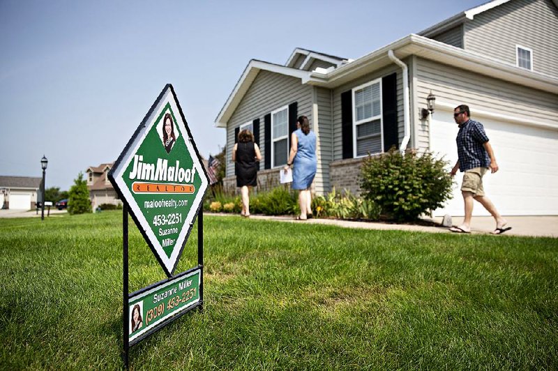 Prospective homebuyers tour a house for sale last summer in Dunlap, Ill. Home sales for last year were at the weakest pace since 2015. 