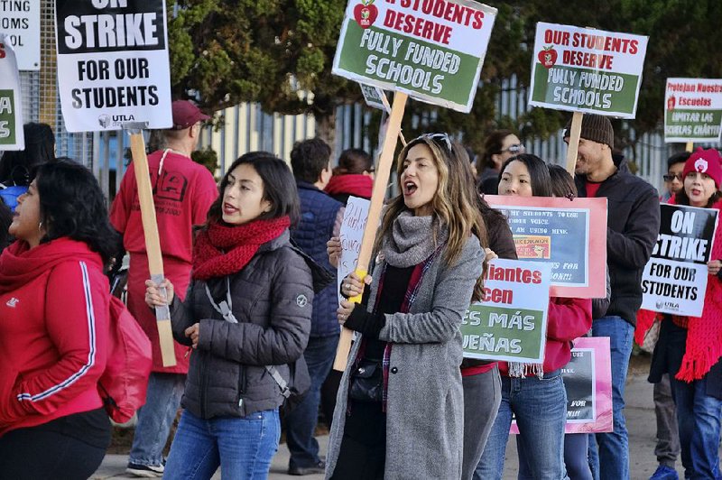 Striking Los Angeles teachers are joined on the picket line Tuesday by parents and students in front of Evelyn Thurman Gratts Elementary School. 