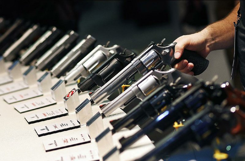 Handguns sit on display at the Shooting, Hunting and Outdoor Trade show in Las Vegas in January 2016. This year’s annual conference runs from today through Friday in Las Vegas. 