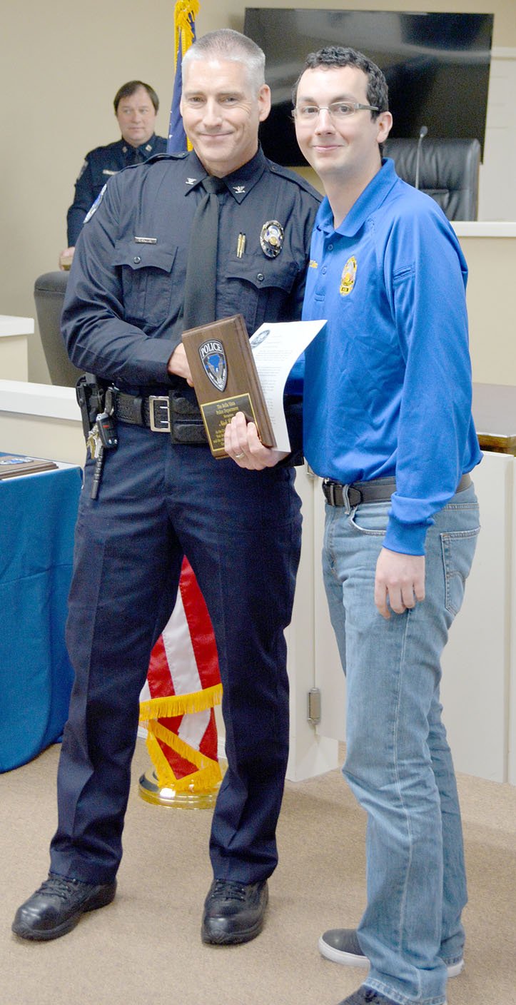 Keith Bryant/The Weekly Vista Bella Vista police chief James Graves (left) stands with the department's civilian of the year, dispatcher Nick Collins.