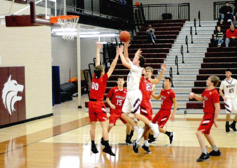 MARK HUMPHREY ENTERPRISE-LEADER Lincoln senior Sterling Morphis beats all five Mansfield defenders to the spot penetrating the lane for a high-percentage shot. Morphis led the Wolves to a 74-62 conference win over Mansfield on Friday.