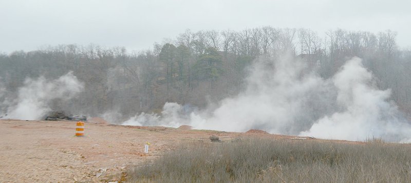 Smoke rises from the Trafalgar Road fire site Thursday after a rainy night.