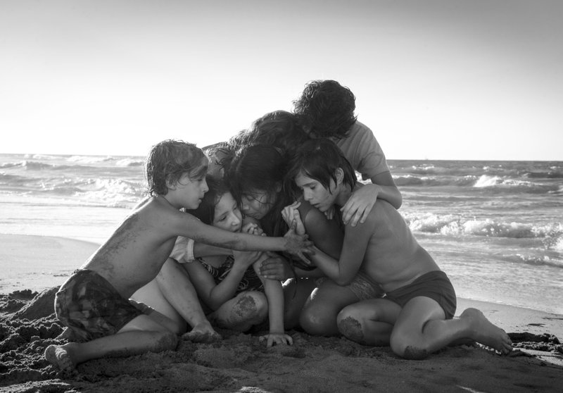 This image released by Netflix shows Yalitza Aparicio, center, in a scene from the film "Roma" by filmmaker Alfonso Cuaron. On Tuesday, Jan. 22, 2019, the film was nominated for an Oscar for both best foreign language film and best picture.  (Carlos Somonte/Netflix via AP)
