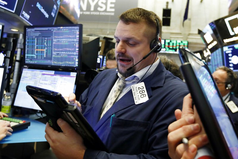 In this Jan. 18, 2019, file photo trader Michael Milano works on the floor of the New York Stock Exchange. The U.S. stock market opens at 9:30 a.m. EST on Wednesday, Jan. 23. (AP Photo/Richard Drew, File)