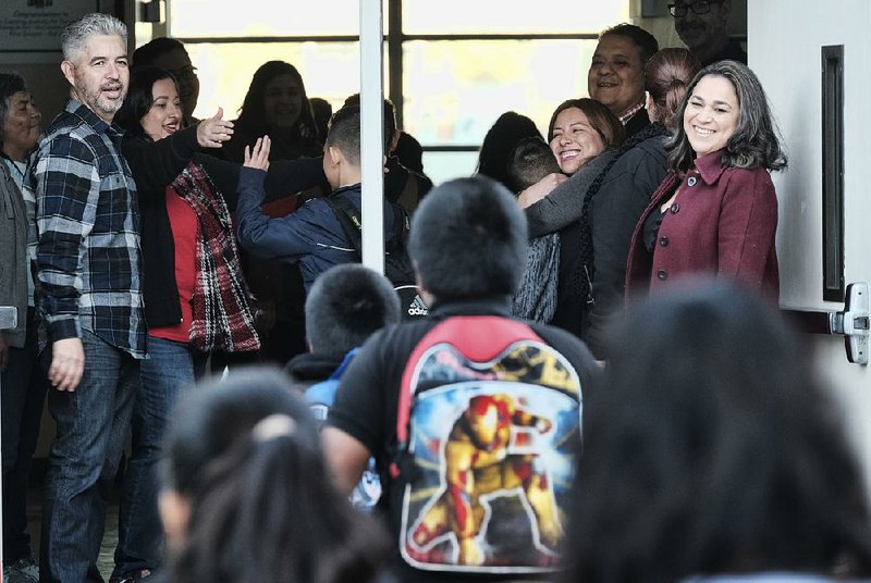 Teachers and administrators welcome students to Evelyn Thurman Gratts Elementary School in Los Angeles on Wednesday, the first day of school since the six-day teachers strike ended.  