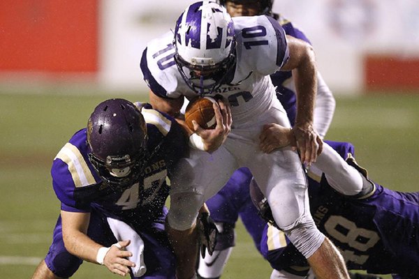 Junction City linebacker Tanner Barnett (47) and defensive end Kyle Kidwell (48) tackle Hazen quarterback Blayne Toll (10) during the first quarter of Junction City's 36-22 win in the Class 2A state championship game on Friday, Dec. 7, 2018, at War Memorial Stadium in Little Rock. 
