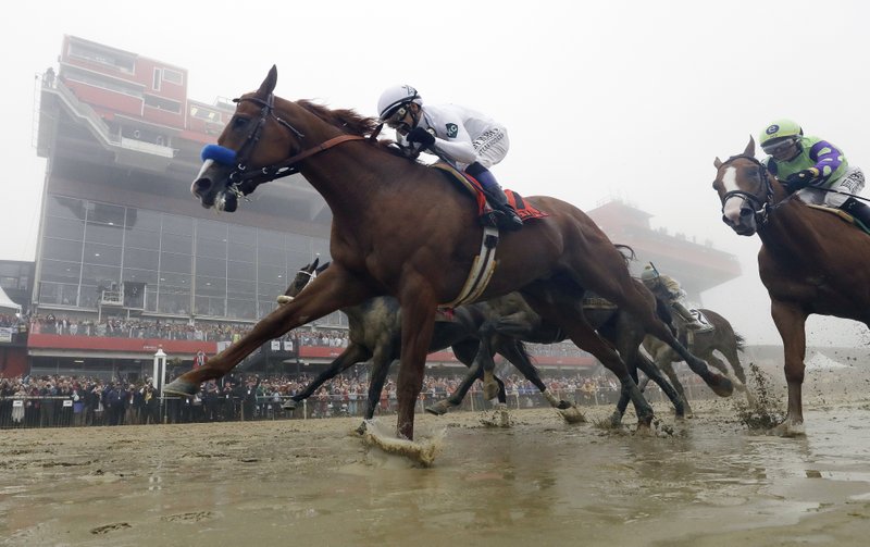 In this May 19, 2018, file photo, Justify, with Mike Smith aboard, wins the 143rd Preakness Stakes horse race at Pimlico race course in Baltimore. Justify finished unbeaten, on and off the track.  (AP Photo/Patrick Semansky, File)