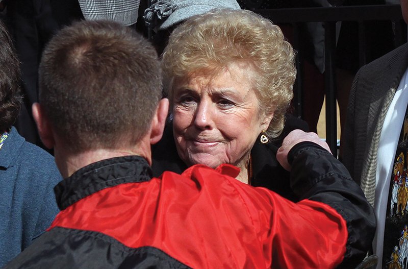 SPECIAL HONOR: Jockey Joe Johnson gives Jeannette Snyder, right, a hug following the first race in the Larry Snyder Winner's Circle at Oaklawn Park Friday. Jeanette Snyder, wife of legendary jockey and longtime Oaklawn steward Larry Snyder, presented the winning connections in the new winner's circle.