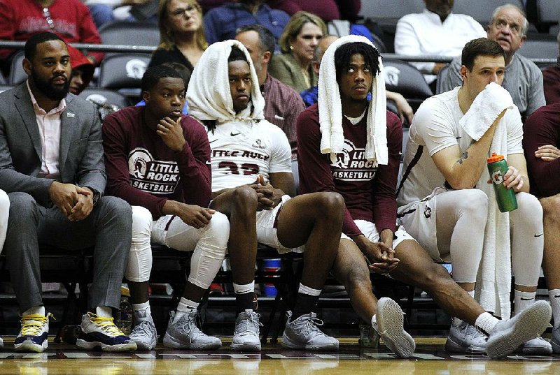 UALR’s Kris Bankston (left) and Horace Wyatt sit dejectedly on the bench during the second half of the Trojans’ loss to Appalachian State on Saturday at the Jack Stephens Center in Little Rock.