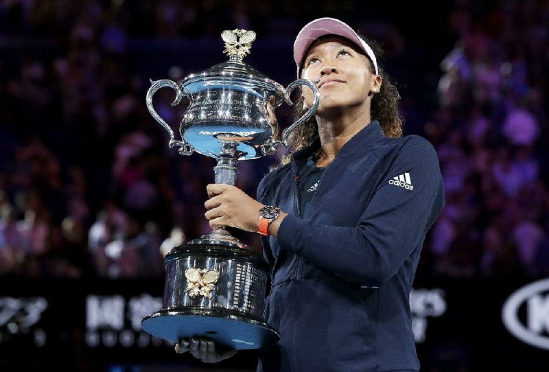 Naomi Osaka poses with the Australian Open trophy after Saturday’s match in Melbourne, Australia.