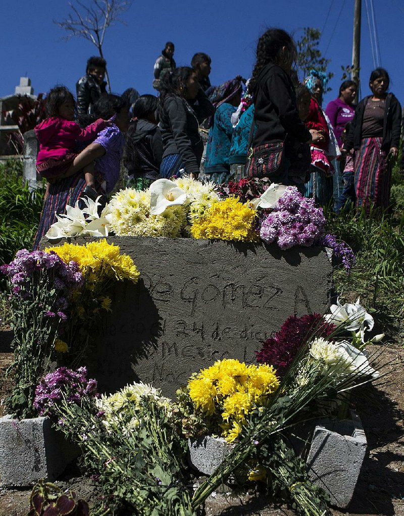 The name of Felipe Gomez Alonzo, an 8-year-old Guatemalan who died in U.S. custody last month, is handwritten in the cement of his tombstone at a cemetery in Yalambojoch, Guatemala, where he was buried Sunday. The boy died of an illness days after he and his father were apprehended as hey tried to cross the U.S.-Mexico border. 