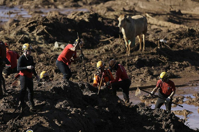 Firefighters dig Monday for victims of a dam collapse in Brumadinho, Brazil, as searchers concentrated on the buried cafeteria of the Vale mining company. 