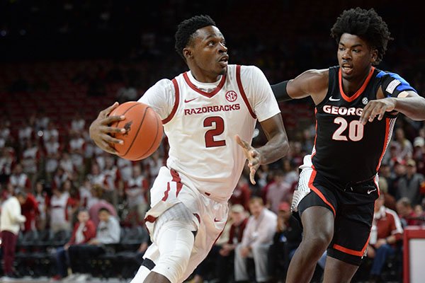 Arkansas forward Adrio Bailey (2) drives to the basket as he is guarded by Georgia forward Rayshaun Hammonds (20) Tuesday, Jan. 29, 2019, during the first half of play in Bud Walton Arena. 
