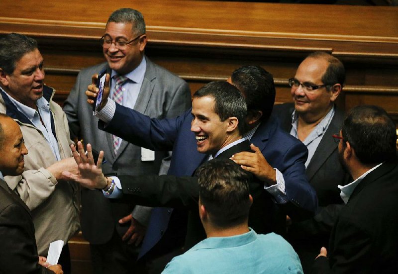 Venezuelan opposition leader Juan Guaido (center) arrives Tuesday at the National Assembly in Caracas. 