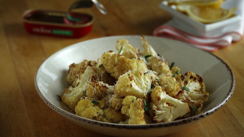 Garlic, anchovies, lemon and parsley flavor a simple-to-prepare roasted cauliflower dish. (E. Jason Wambsgans/Chicago Tribune/TNS)