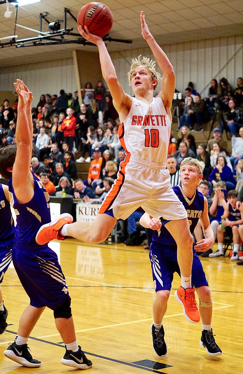 Westside Eagle Observer/RANDY MOLL Gravette sophomore Cy Hilger goes up for two in play against the visiting Berryville Bobcats on Friday in Lion Field House.