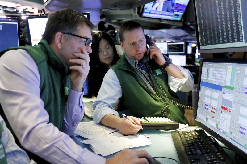 Specialists David Haubner, left, Vera Liu, center, and Robert Nelson work on the floor of the New York Stock Exchange, Tuesday, Jan. 29, 2019. Stocks are opening slightly higher on Wall Street as several big U.S. companies reported solid results for the latest quarter. (AP Photo/Richard Drew)