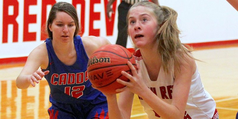 The Sentinel-Record/Richard Rasmussen ROUGH GOING: Mountain Pine sophomore Ramsey Monroe, right, goes up for a shot Tuesday as Caddo Hills junior Abby West (12) defends during the first half of the Lady Indians' 60-9 road win at Red Devil Fieldhouse.