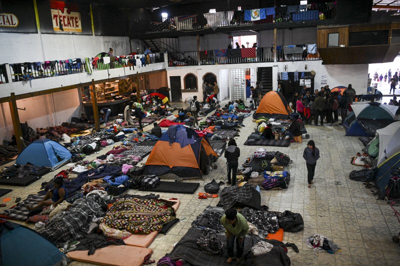 Members of the migrant caravan spend time on Dec. 1 in a shuttered club called El Barretal in Tijuana, Mexico, that was turned into a temporary shelter for migrants, many of whom are seeking asylum in the U.S. Washington Post photo by Carolyn Van Houten