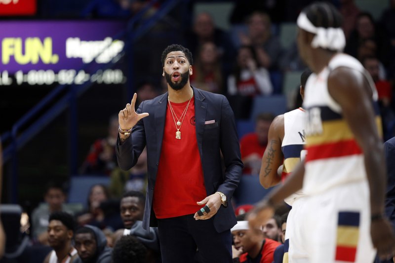 New Orleans Pelicans forward Anthony Davis talks to guard Jrue Holiday, foreground, in the second half of an NBA basketball game in New Orleans, Wednesday, Jan. 23, 2019. 