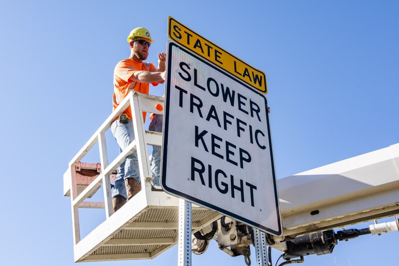 The Arkansas Department of Transportation is installing yellow "State Law" signs above existing signs that say "Slower Traffic Keep Right." Photo courtesy of the state Department of Transportation
