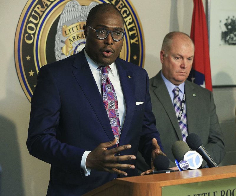 Mayor Frank Scott Jr. (left), with interim Police Chief Wayne Bewley, speaks Wednesday at the Little Rock Police Department in the wake of Tuesday night’s slayings and urged people to report domestic disturbances to authorities. 