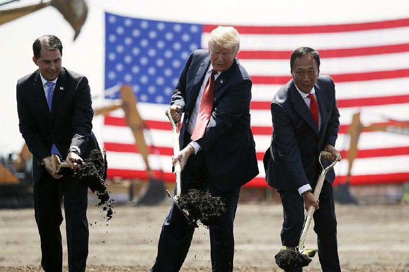 President Donald Trump, flanked by Wisconsin Gov. Scott Walker (left) and Foxconn executive Terry Gou, participates in a groundbreaking event last June for the planned Foxconn facility in Mount Pleasant, Wis.