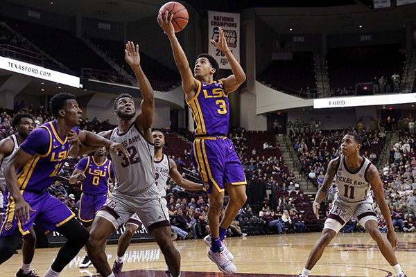 LSU guard Tremont Waters (3) shoots over Texas A&M forward Josh Nebo (32) as LSU forward Kavell Bigby-Williams, left, and Texas A&M guard Wendell Mitchell, right, watch during the second half of an NCAA college basketball game Wednesday, Jan. 30, 2019, in College Station, Texas. (AP Photo/Michael Wyke)