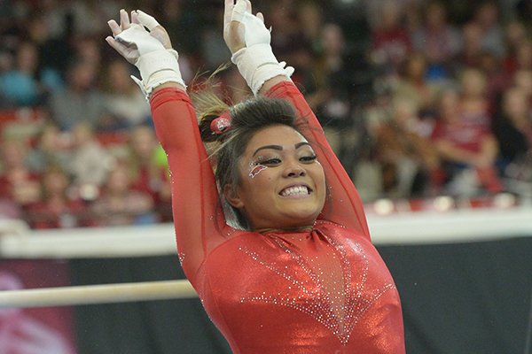 Arkansas' Jessica Yamzon competes in the bars Saturday, Jan. 5, 2019, during the Razorbacks' meet with No. 2 Oklahoma in Barnhill Arena in Fayetteville.