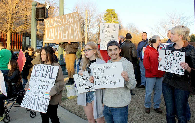 Northwest Arkansas Democrat-Gazette File Photo
Citizens gather Friday, Feb. 24. 2017 at Dickson Street and College Avenue in Fayetteville in response to the recent decision by the Arkansas Supreme Court to overturn a city ordinance that offers recourse for LGBT people who have been discriminated through housing and employment. 