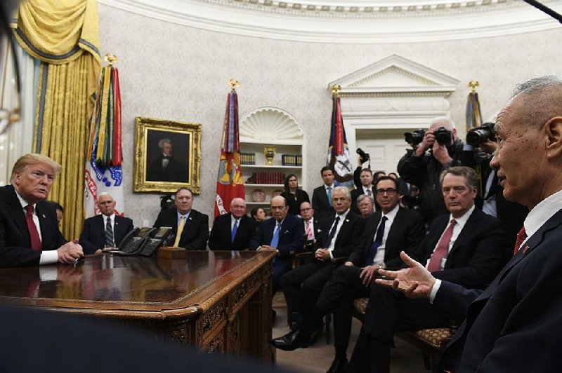 President Donald Trump (left) meets Thursday in the White House with Chinese Vice Premier Liu He (right) on the second day of U.S.-China trade talks in Washington. 