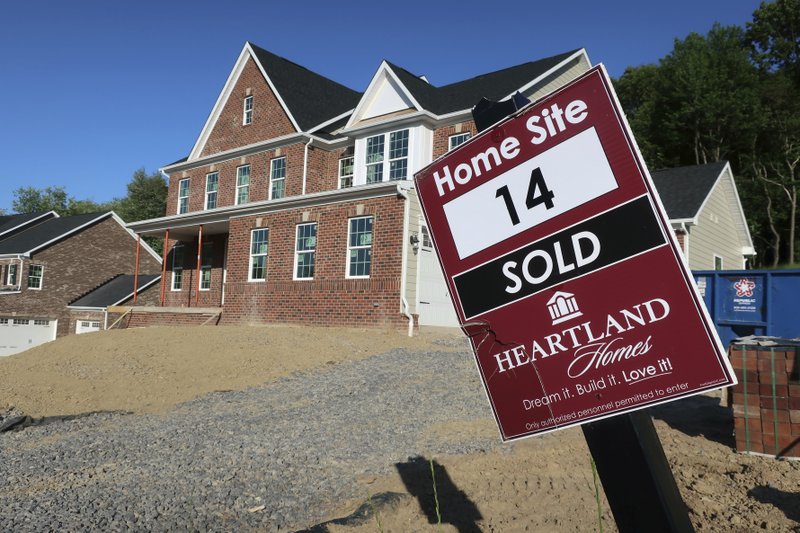 FILE- In this May 25, 2018, file photo shows a sold sign stands in front of a home under construction in Hampton Township, Pa. Sales of new U.S. homes soared in November, defying higher mortgage rates, but they're still below year-ago levels. The Commerce Department said Thursday, Jan. 31, 2019, that new home sales jumped 16.9 percent in November from the previous month to a seasonally adjusted annual rate of 657,000. (AP Photo/Ted Shaffrey, File)