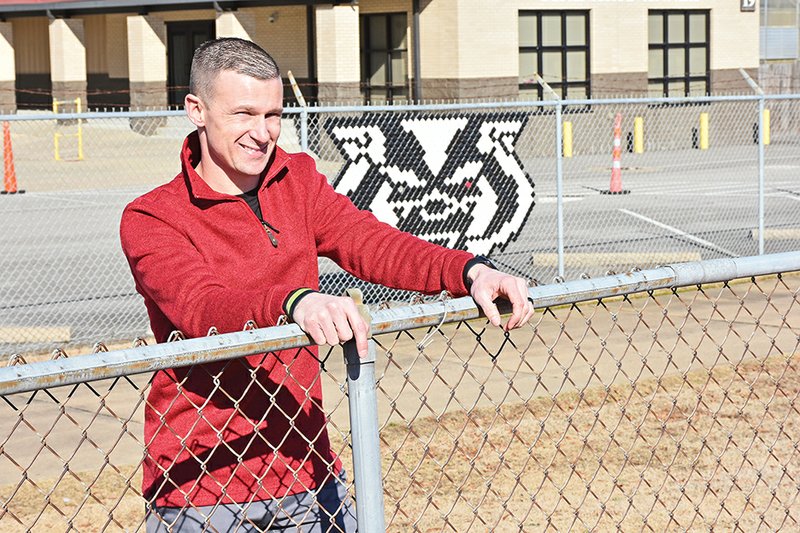 Chris Gunter, the new football coach at Beebe High School, stands at the fence inside “Bro” Erwin Stadium. Gunter, a 2003 graduate of Beebe, was hired to replace John Shannon during the Jan. 21 school-board meeting.
