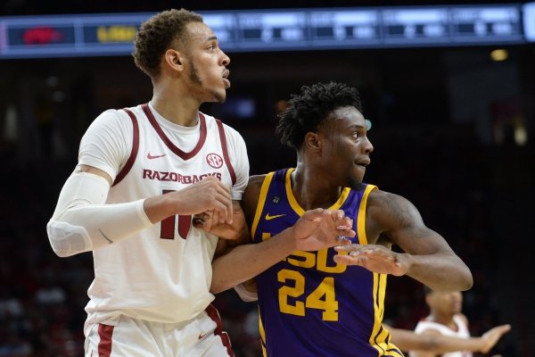 Arkansas forward Daniel Gafford (left) and LSU forward Emmitt Williams battle for position Friday, Jan. 11, 2019, during the second half of play in Bud Walton Arena in Fayetteville. Visit nwadg.com/photos to see more photographs from the game.