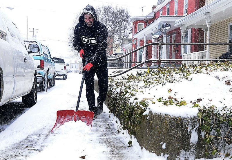 Charles High shovels snow Friday in Hagerstown, Md. Chest pain and shortness of breath from shoveling snow were some of the complaints hospitals received during this week’s freezing weather. 