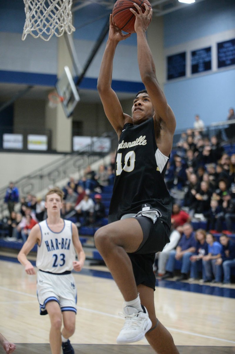 NWA Democrat-Gazette/ANDY SHUPE Bentonville's Connor Deffebaugh (10) reaches to dunk the ball in transition ahead of Springdale Har-Ber's Lawson Jenkins (23) Friday, Feb. 1, 2019, during the first half of play in Wildcat Arena in Springdale. Visit nwadg.com/photos to see more photographs from the games.