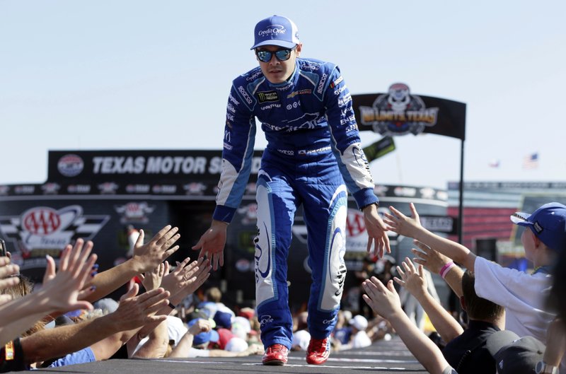FILE - In this Nov. 5, 2017, file photo, Kyle Larson greets fans during driver introductions before the NASCAR Cup Series auto race at Texas Motor Speedway in Fort Worth, Texas. As Larsen enters his sixth season at NASCAR's top level it is clear that once he starts winning on a consistent basis he could become the biggest star in the country. (AP Photo/LM Otero, File)