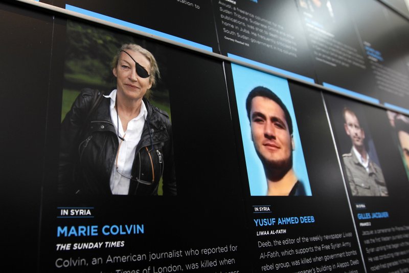 FILE- In this May 13, 2013, file photo, the photo of Journalist Marie Colvin who was killed in Syria while she was reporting from there, is seen on the wall of the Newseum during the Journalist Memorial Re-dedication ceremony of the journalists who died reporting the news in 2012 in Washington. Seven years after Colvin was killed while covering the Syrian revolution, a Washington court has found the Syrian government liable and awarded more than $300 million in damages (AP Photo/Jose Luis Magana, File)