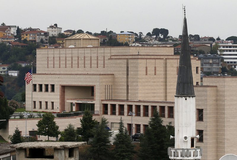 FILE - In this Tuesday, Aug. 11, 2015 file photo, a mosque's minaret is seen backdropped by the United States consulate building in Istanbul. Metin Topuz, a translator and fixer for the Drug Enforcement Agency, working at the consulate, is set to go on trial in March on charges of espionage and attempting to overthrow the Turkish government, a court decided Friday, Feb. 1, 2019. Topuz, has been in custody since October 2017. (AP Photo/Emrah Gurel, FILE)