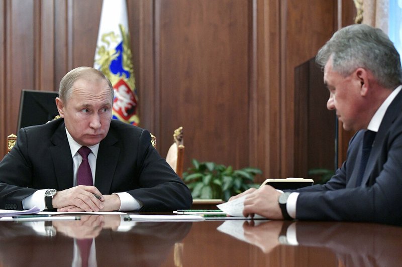Russian President Vladimir Putin, left, speaks to Defense Minister Sergei Shoigu during a meeting in the Kremlin in Moscow, Russia, Saturday, Feb. 2, 2019. Putin said that Russia will abandon the 1987 Intermediate-Range Nuclear Forces treaty, following in the footsteps of the United States, but noted that Moscow will only deploy intermediate-range nuclear missiles if Washington does so. 
