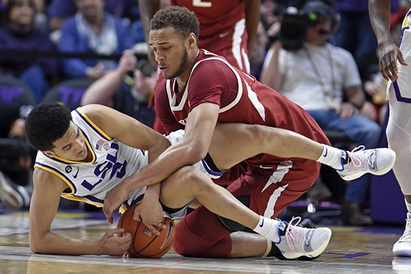 LSU guard Tremont Waters (3) and Arkansas forward Daniel Gafford (10) scramble for the ball during the first half of an NCAA college basketball game Saturday, Feb. 2, 2019, in Baton Rouge, La. (AP Photo/Bill Feig)

