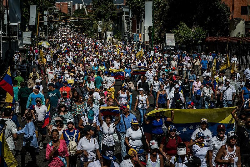 Supporters of Venezuelan opposition leader Juan Guaido march Saturday in Caracas in one of the largest demonstrations ever against President Nicolas Maduro. 