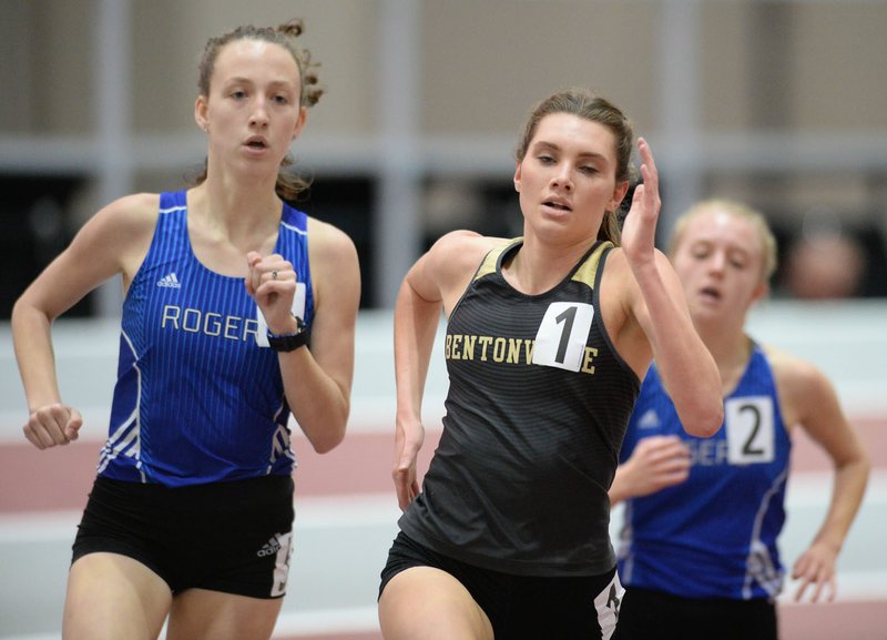 NWA Democrat-Gazette/ANDY SHUPE Lainey Quandt (center) of Bentonville and Ali Nachtigal of Rogers (left) pull away from Anna Jeffcoat of Rogers while competing in the 1,600 meters Saturday, Feb. 2, 2019, during the 5A-6A State Indoor Track and Field Championship in the Randal Tyson Track Center in Fayetteville. Quandt and Nachtigal tied at 5:14:53 minutes. Visit nwadg.com/photos to see more photographs from the meet.